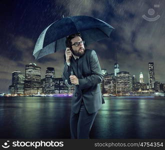 Afraid businessman in the heavy rain