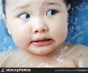 Afraid child in the bath. Close-up horizontal photo