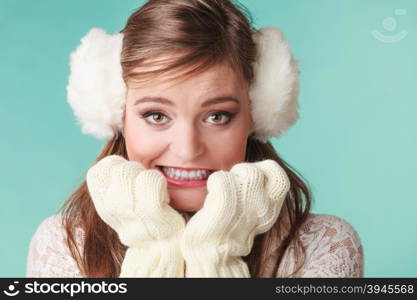 Afraid cute pretty woman girl in earmuffs.. Portrait of funny afraid cute pretty woman in earmuffs. Lovely girl in studio on green.