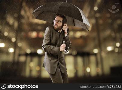 Afraid smart businessman standing under the umbrella