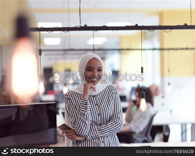 african americam modern muslim businesswoman portrait  wearing hijab at creative modern startup coworking open space office