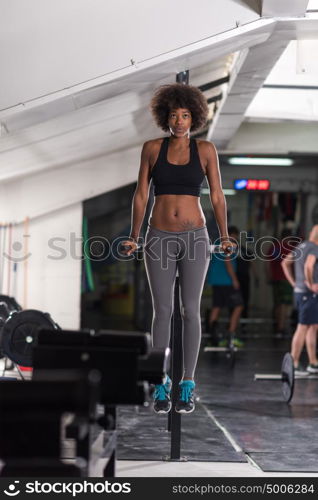 african american athlete woman workout out arms on dips horizontal parallel bars Exercise training triceps and biceps doing push ups