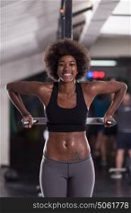 african american athlete woman workout out arms on dips horizontal parallel bars Exercise training triceps and biceps doing push ups