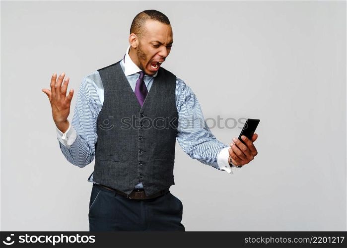 african-american business man talking on mobile phone - stress and negativity.. african-american business man talking on mobile phone - stress and negativity