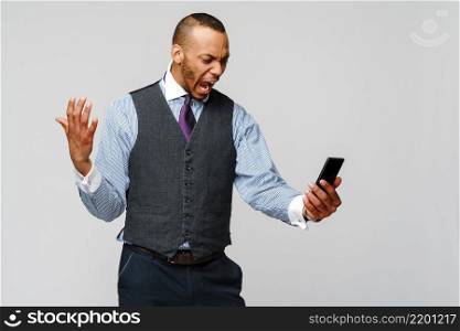 african-american business man talking on mobile phone - stress and negativity.. african-american business man talking on mobile phone - stress and negativity