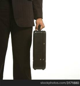 African American businessman in suit holding briefcase.