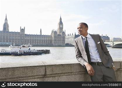 African American businessman leaning with hand in pocket