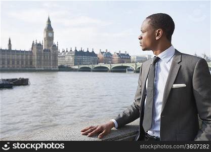African American businessman looking at buildings