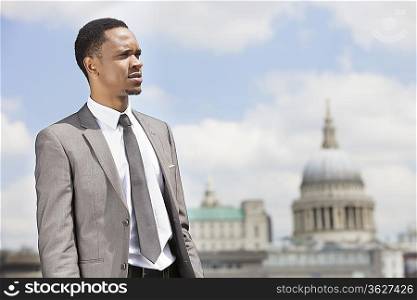 African American businessman looking away with St. Paul&acute;s Cathedral in the background