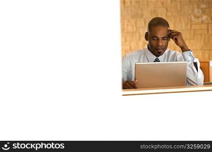 African-american businessman working on laptop.