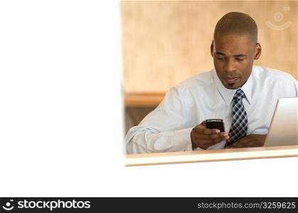African-american businessman working on PDA.