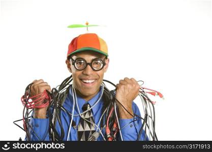 African American businessman wrapped in computer cables wearing nerd hat and glasses.