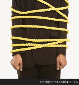 African American businessman wrapped in yellow rope.