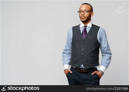 African-American businessmanman wearing glasses portrait over grey background.. African-American businessmanman wearing glasses portrait over grey background