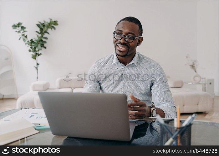 African american businessperson adviser or lawyer talking with client, distance working online at laptop. Professional marketing manager communicating with customers by video conference at home office. African american businessperson distance working, communicate with customer at laptop, discuss deal