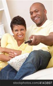 African American Couple Eating Popcorn Watching Television