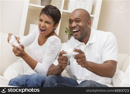 African American couple, man and woman, having fun playing video console games together.