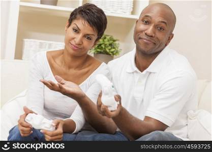 African American couple, man and woman, having fun playing video console games together. The woman has just beaten the man, she is celebrating, he is resigned.
