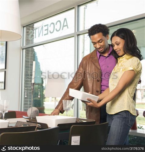 African American couple shopping in retail store.