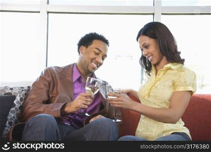African American couple toasting with wine glasses.