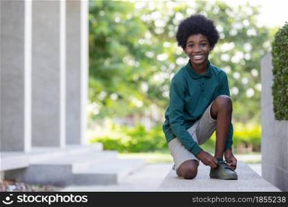 African American curly hair boys smiling and looking camera at outdoor.