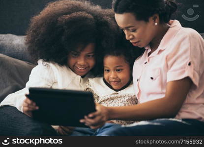 african american family at home, mom and children