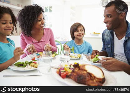 African American Family Eating Meal At Home Together