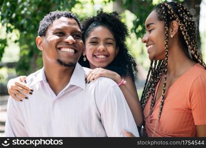 African American family having fun and enjoying a day together outdoors at the park.