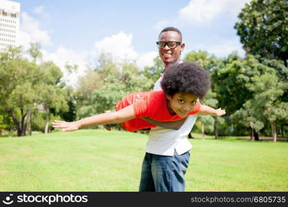 African American family having fun in the outdoor park during summer