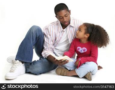 African American father and daughter reading child&acute;s bible