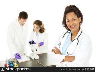 African-american female doctor with lab techs in background. Isolated on white.