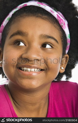 African American girl wearing headband looking to the side.