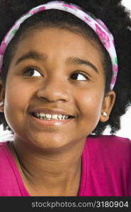 African American girl wearing headband looking to the side.