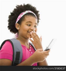 African American girl with backpack talking on cell phone.
