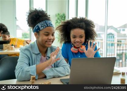 African American girl with friend watch video lesson on computer at home,Happy little childrens have online web class using laptop,Distance education.
