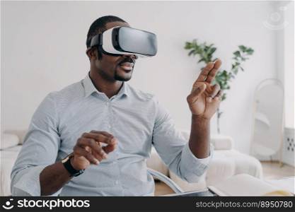 African american male developer or designer wear augmented reality glasses work with 3d objects. Professional employee of high-tech department use virtual reality modeling software. Future high tech. African american man developer in VR glasses use virtual reality modeling software. Future high tech