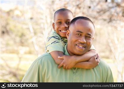 African American Man and Child Having Fun in the Park.