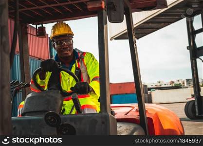 African american man driving forklift in shipyard . Logistics supply chain management and international goods export concept .. African american man driving forklift in shipyard