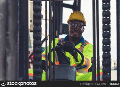 African american man driving forklift in shipyard . Logistics supply chain management and international goods export concept .. African american man driving forklift in shipyard