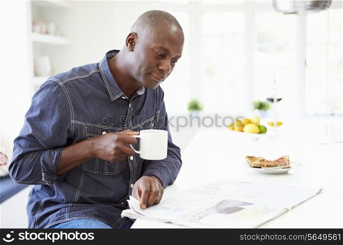 African American Man Eating Breakfast And Reading Newspaper