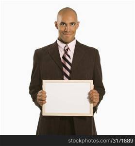 African American man holding blank sign standing against white background.