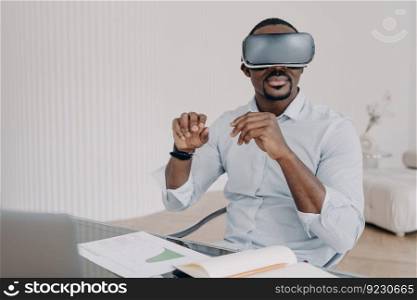 African american man in virtual reality glasses at home. Businessman has online meeting. Freelancer is working on design project. Innovations and digital technology for business and creativity.. African american man in virtual reality glasses at home. Businessman has online meeting.