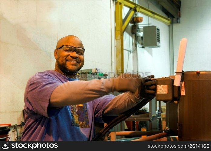African American man operating a piece of machinery
