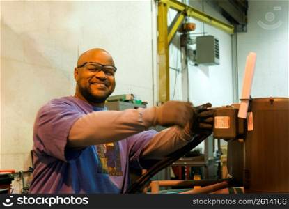 African American man operating a piece of machinery