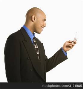 African American man smiling and using cellphone.