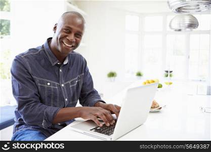African American Man Using Laptop At Home