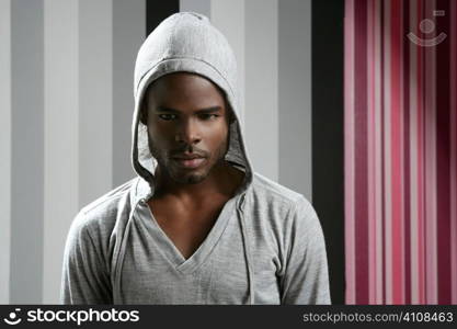 African american man with gray hood over wallpaper background