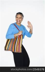 African American mature adult female holding big purse.