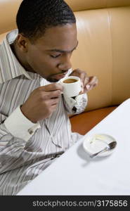 African American mid adult man drinking expresso.