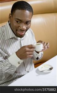 African American mid adult man drinking expresso.